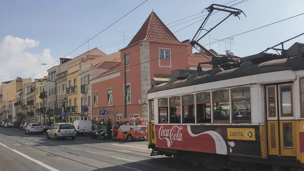 The street near the Pastéis de Belém bakery and a Lisbon cable car.