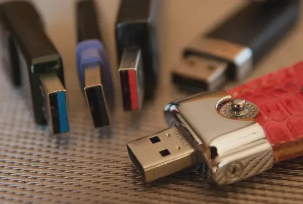 This image is of a collection of old USB sticks that can be used with digital signage.